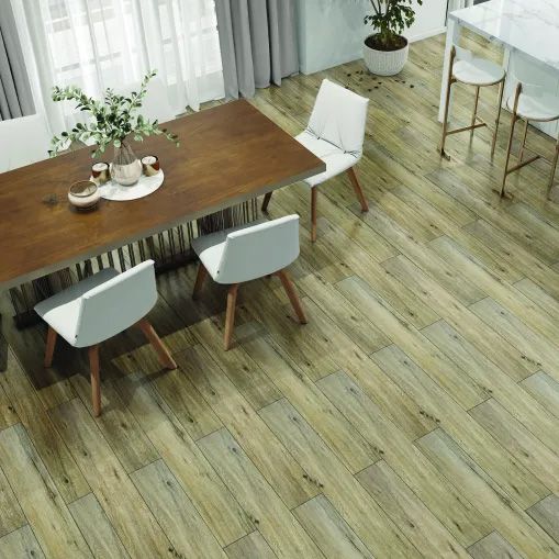 A dining room with a wooden table and chairs and a wooden floor.
