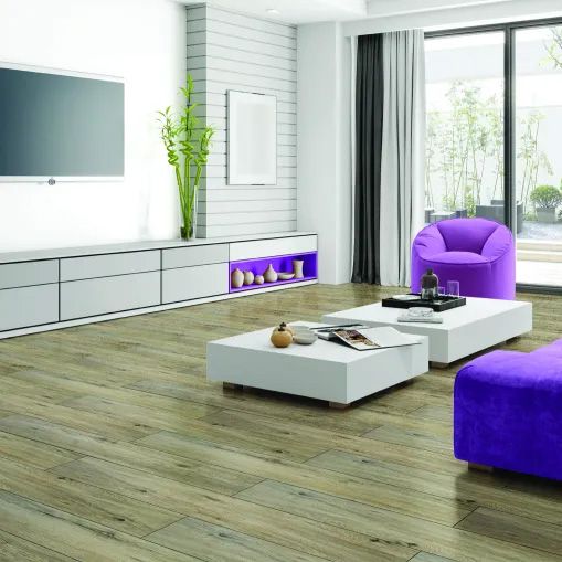 A living room with a purple chair and a white coffee table