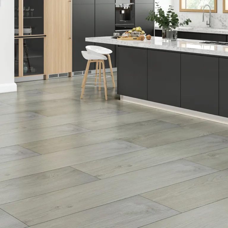 A kitchen with a LVP wooden floor and black cabinets