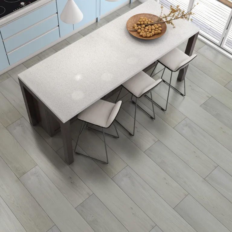 A kitchen with a table and chairs and a bowl of nuts on it