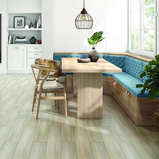 A dining room with a table , chairs , and a bench.