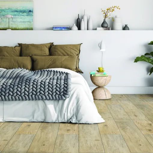 A bedroom with a knitted blanket on the bed