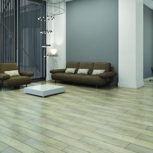 A living room with a couch , chairs , and a coffee table.