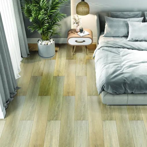 A bedroom with a bed , nightstand , and plant on the floor.