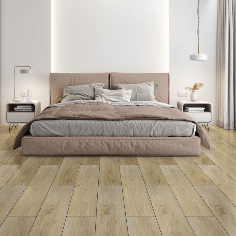 A bedroom with a large bed and wooden floors