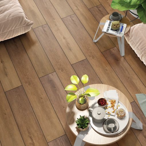 A living room with a wooden floor and a coffee table with plants on it.