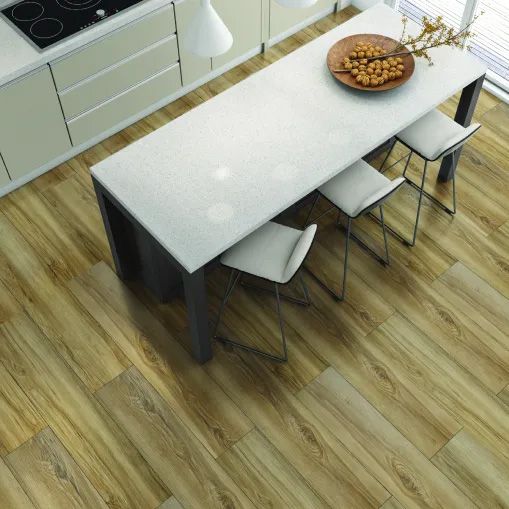 A kitchen with a table and chairs and a plate of food on it.