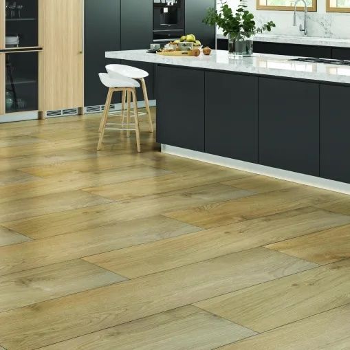 A kitchen with a LVP wooden floor and black cabinets
