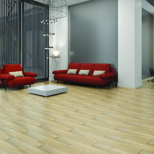 A living room with a red couch and two red chairs