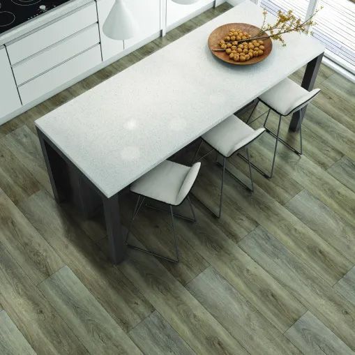 A kitchen with a table and chairs and a bowl of nuts on it