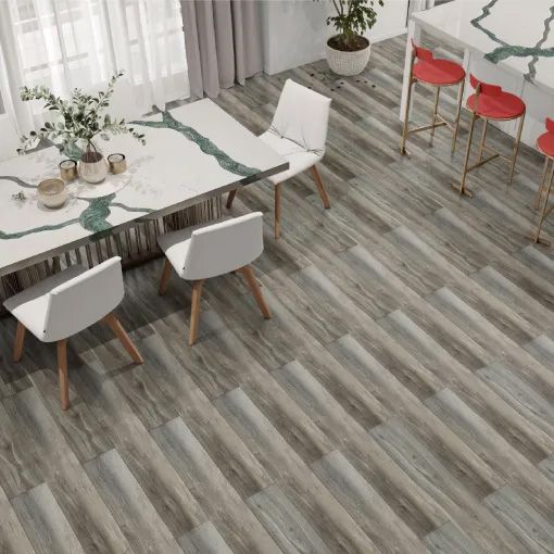A dining room with a table and chairs and a wooden floor.