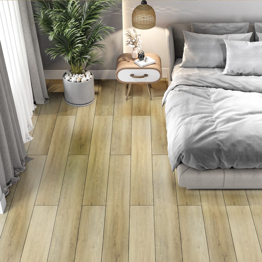A bedroom with a bed , nightstand , and plant on the floor.