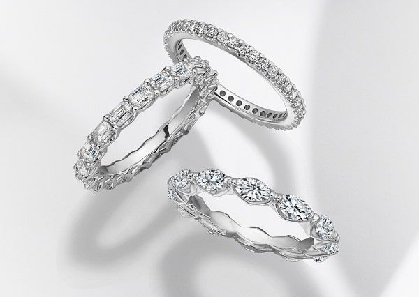 Three diamond eternity rings on white background.