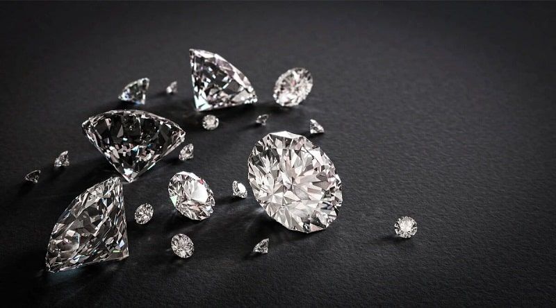 Diamonds scattered on a black surface.