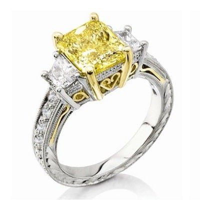 Yellow diamond ring with white diamonds and gold accents on a silver band.