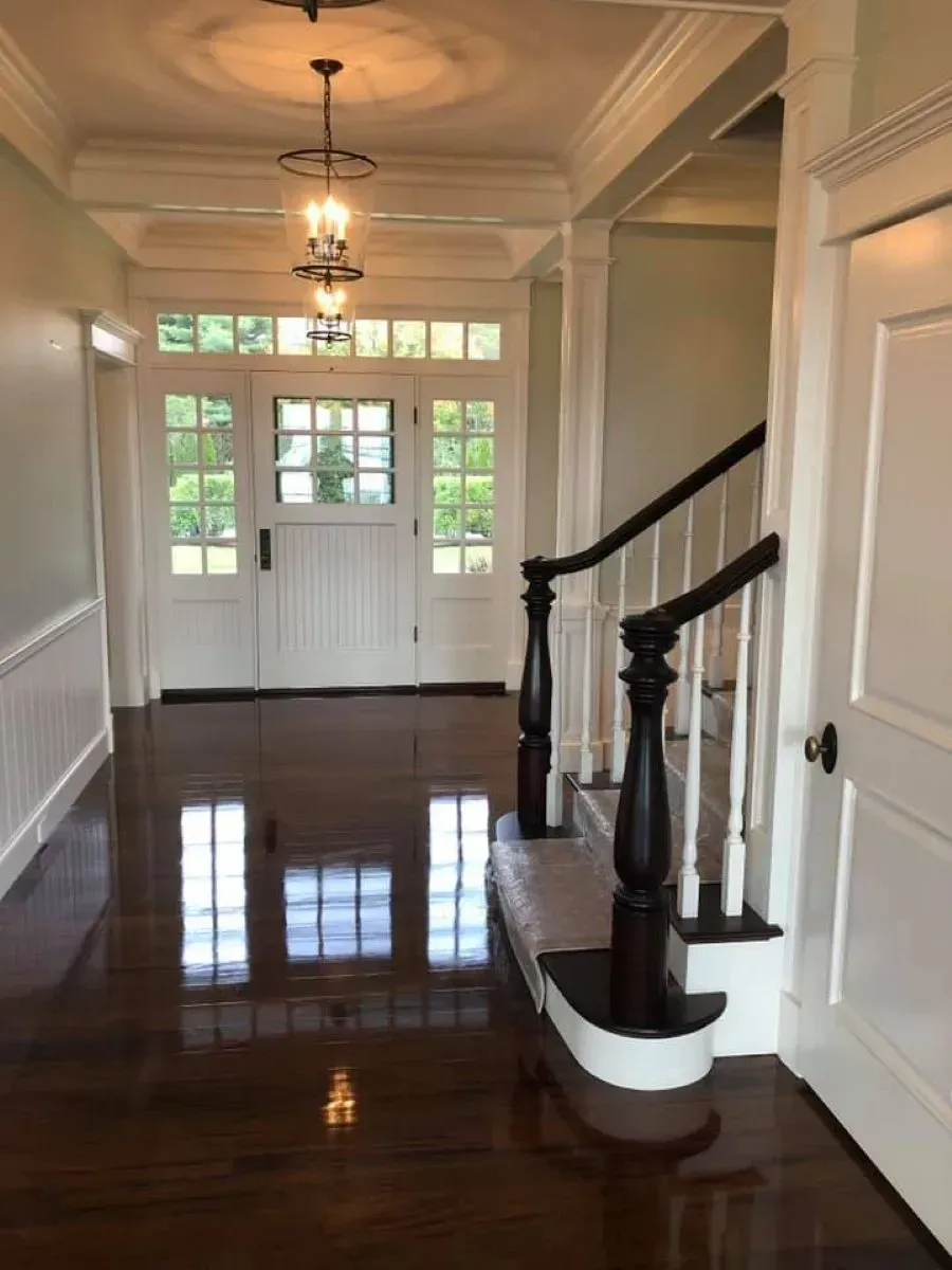 An empty hallway with stairs and a door