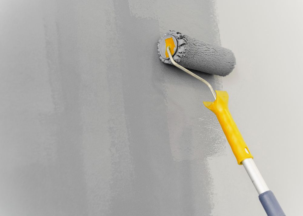 Gray paint roller on wall