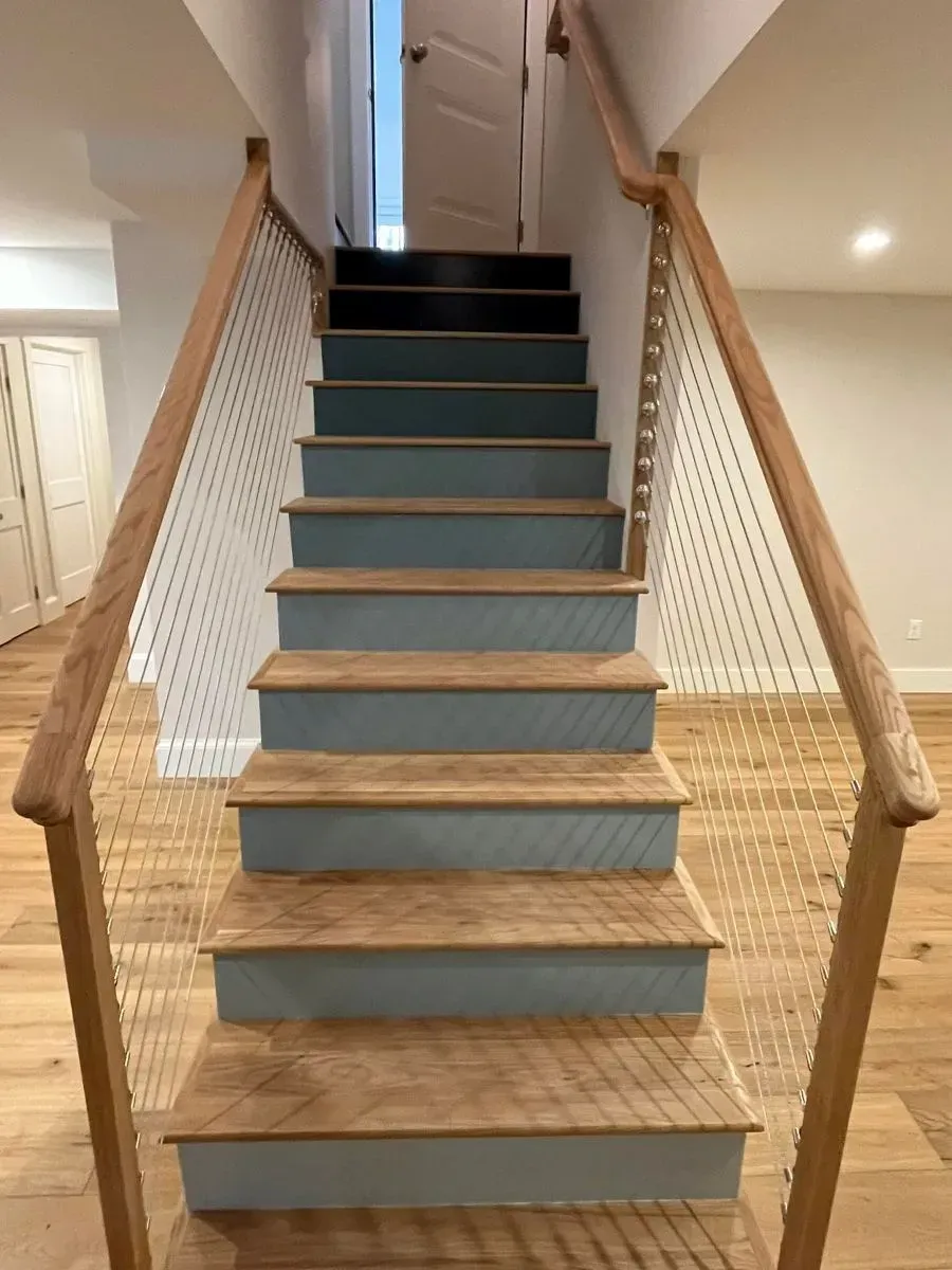 The stairs are painted blue and have a wooden railing.