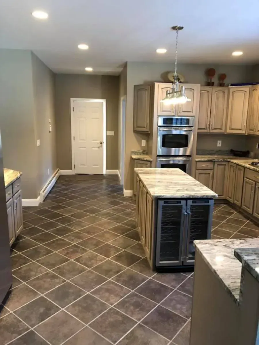 A garage with two garage doors and a shiny floor.