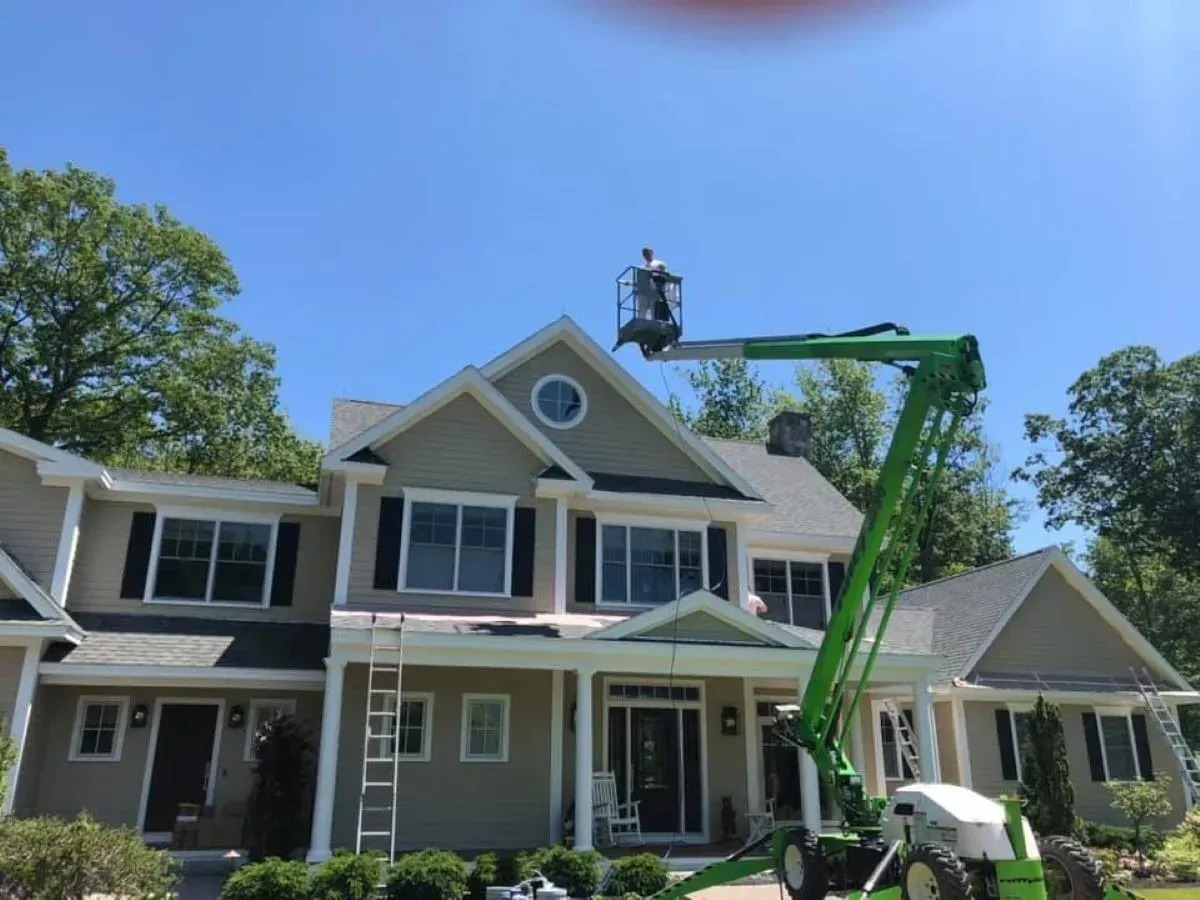 A large house with a green crane in front of it