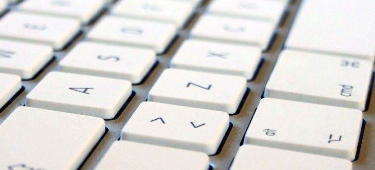 Close-up of white keyboard keys with black letters in a diagonal view
