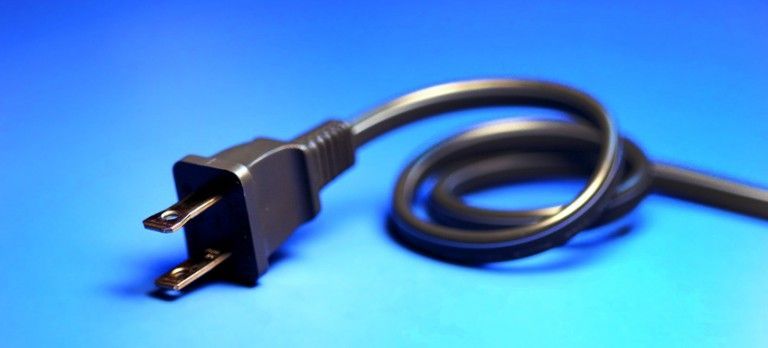 Black electrical power cord with a two-prong plug on a blue background