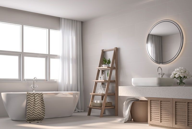 A bathroom with a tub , sink , mirror and window.