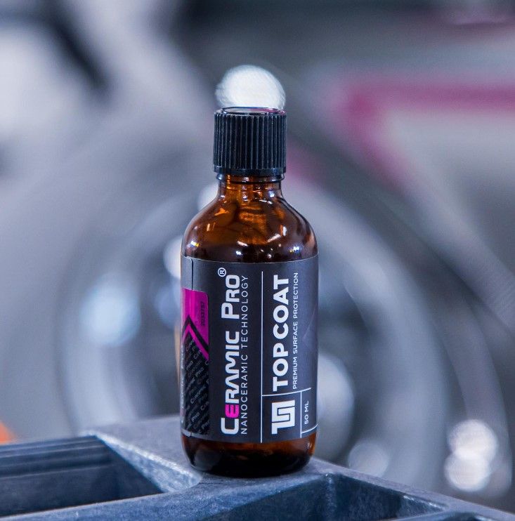 Bottle of Ceramic Pro Top Coat car surface protection.