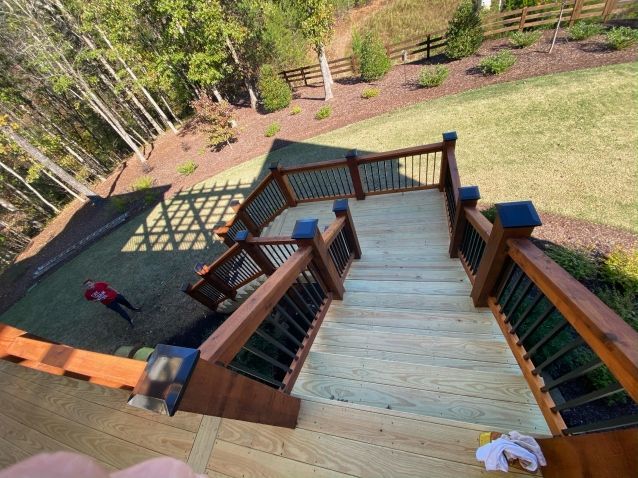An aerial view of a wooden deck with stairs leading up to it