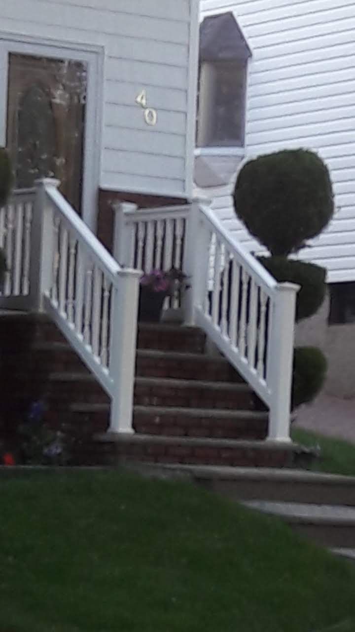 White stairs with white railings lead up to the front entrance of a house numbered 40.