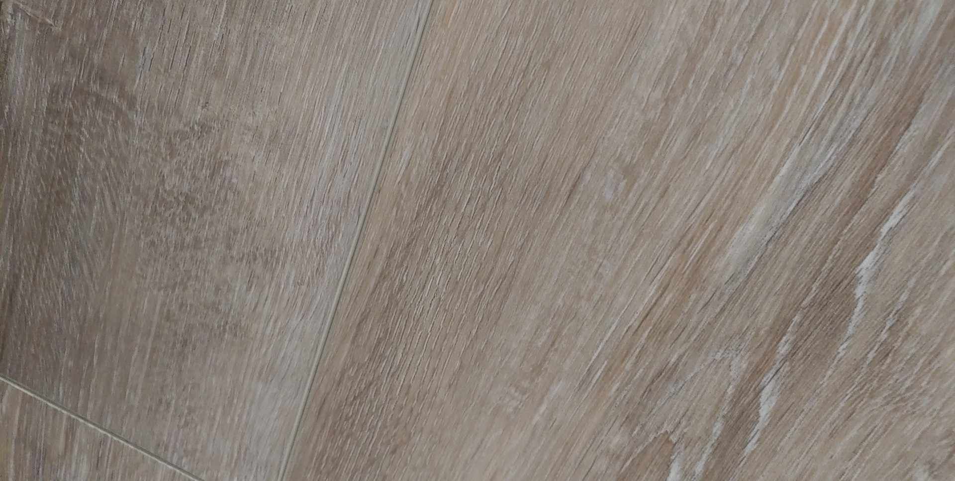 A close up of a piece of wood with a grainy texture.