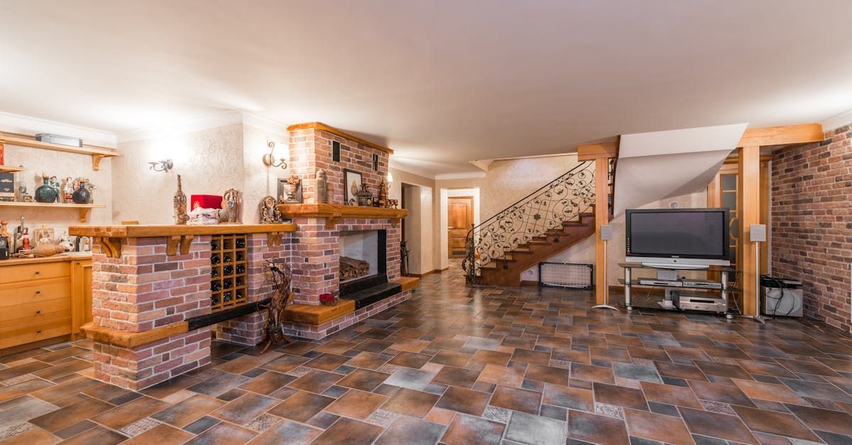 A living room with a fireplace , television , and stairs.