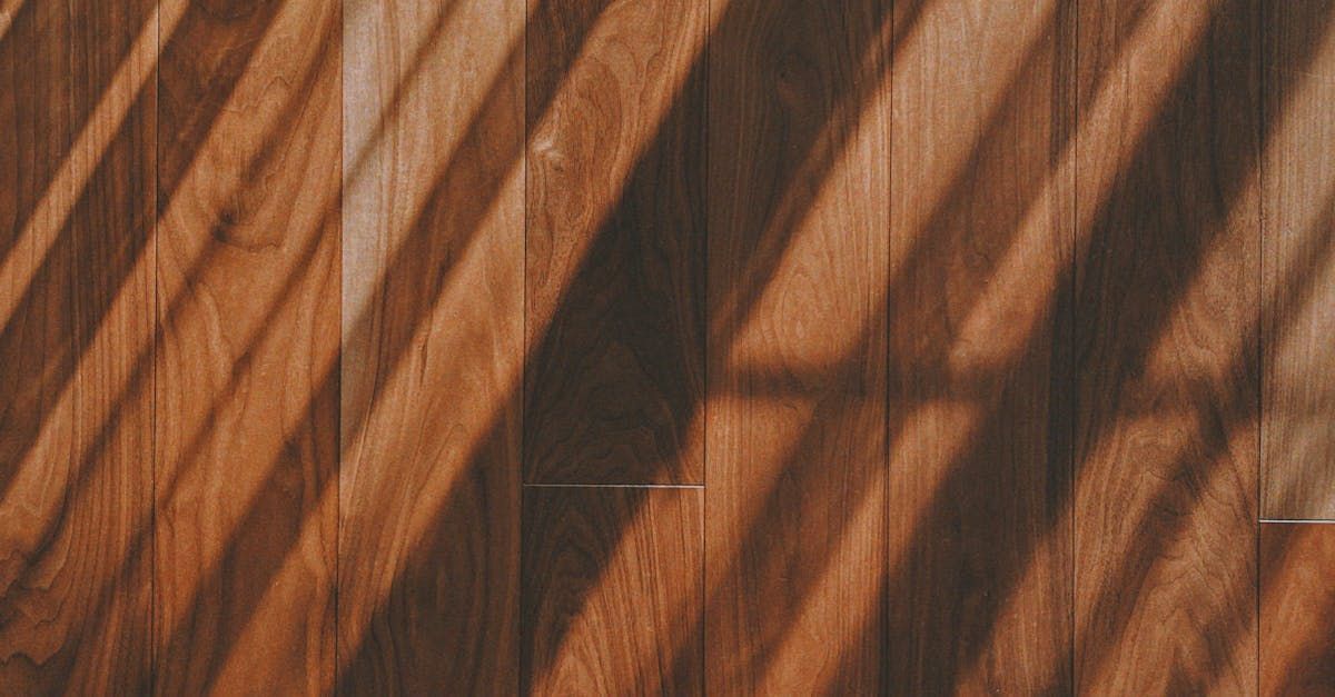 A close up of a wooden wall with a shadow on it.