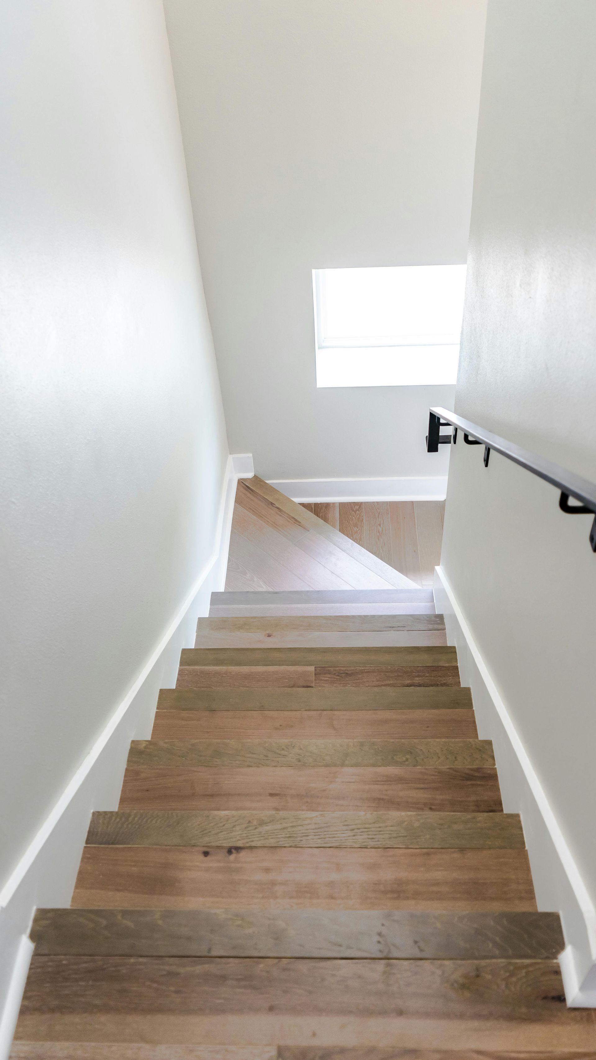 A set of wooden stairs leading up to the second floor of a house.