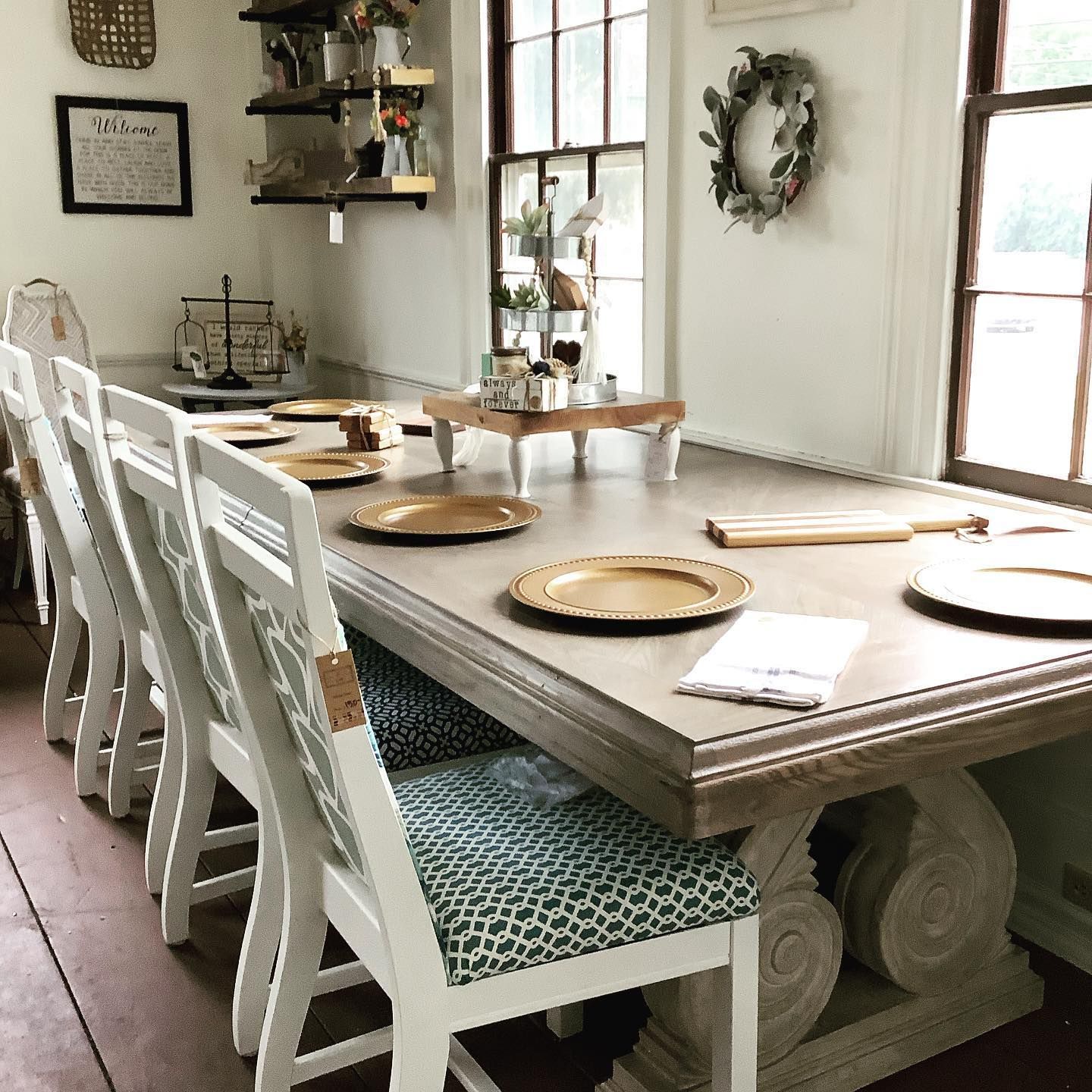 A long table with plates and chairs in a room
