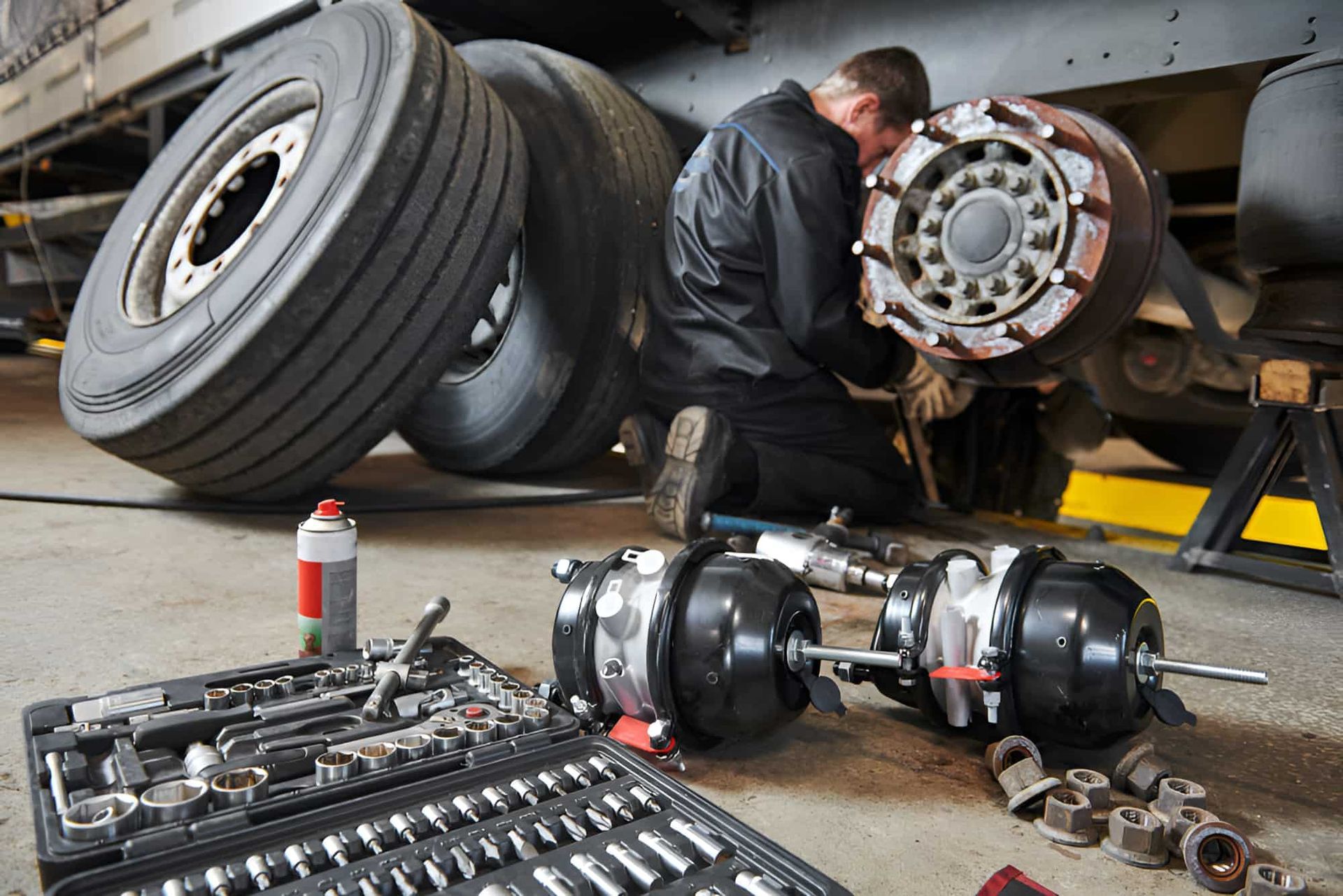 A Man Is Working On A Truck In A Garage — Cameron Brothers Automotive In Currajong, QLD