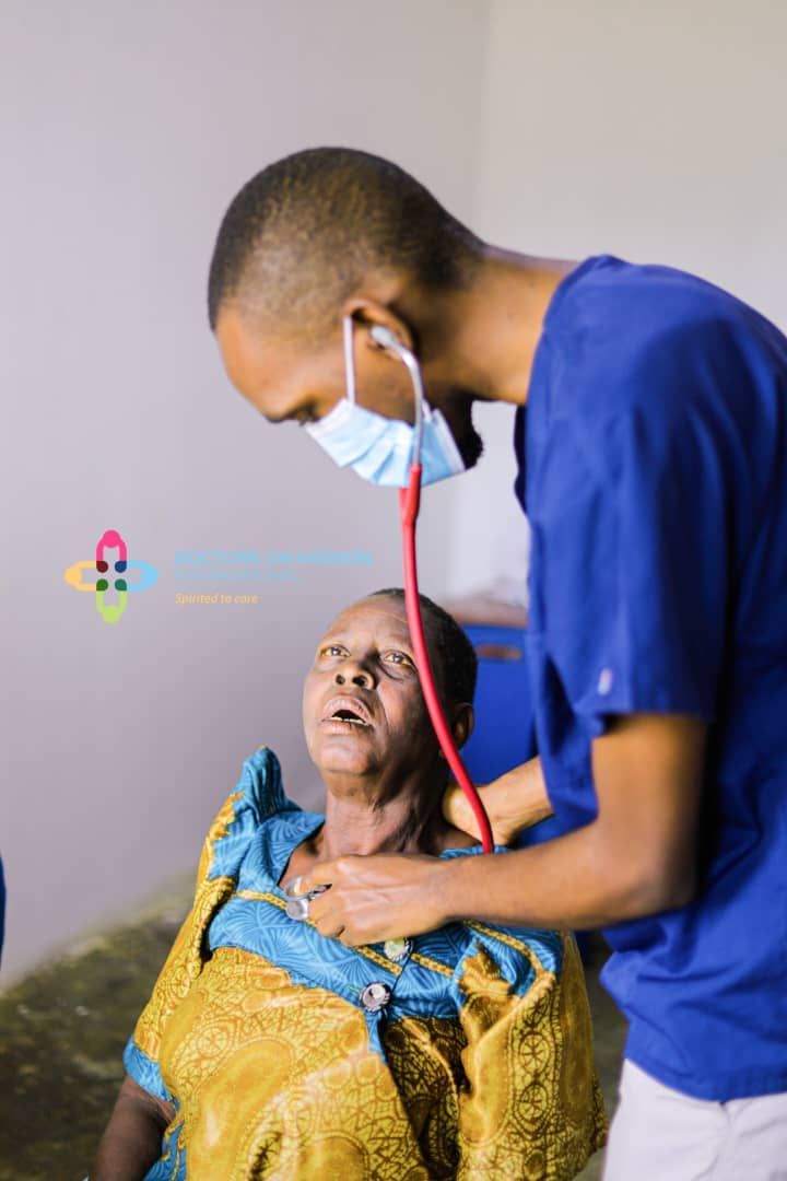 A man is using a stethoscope to listen to a woman 's heartbeat.