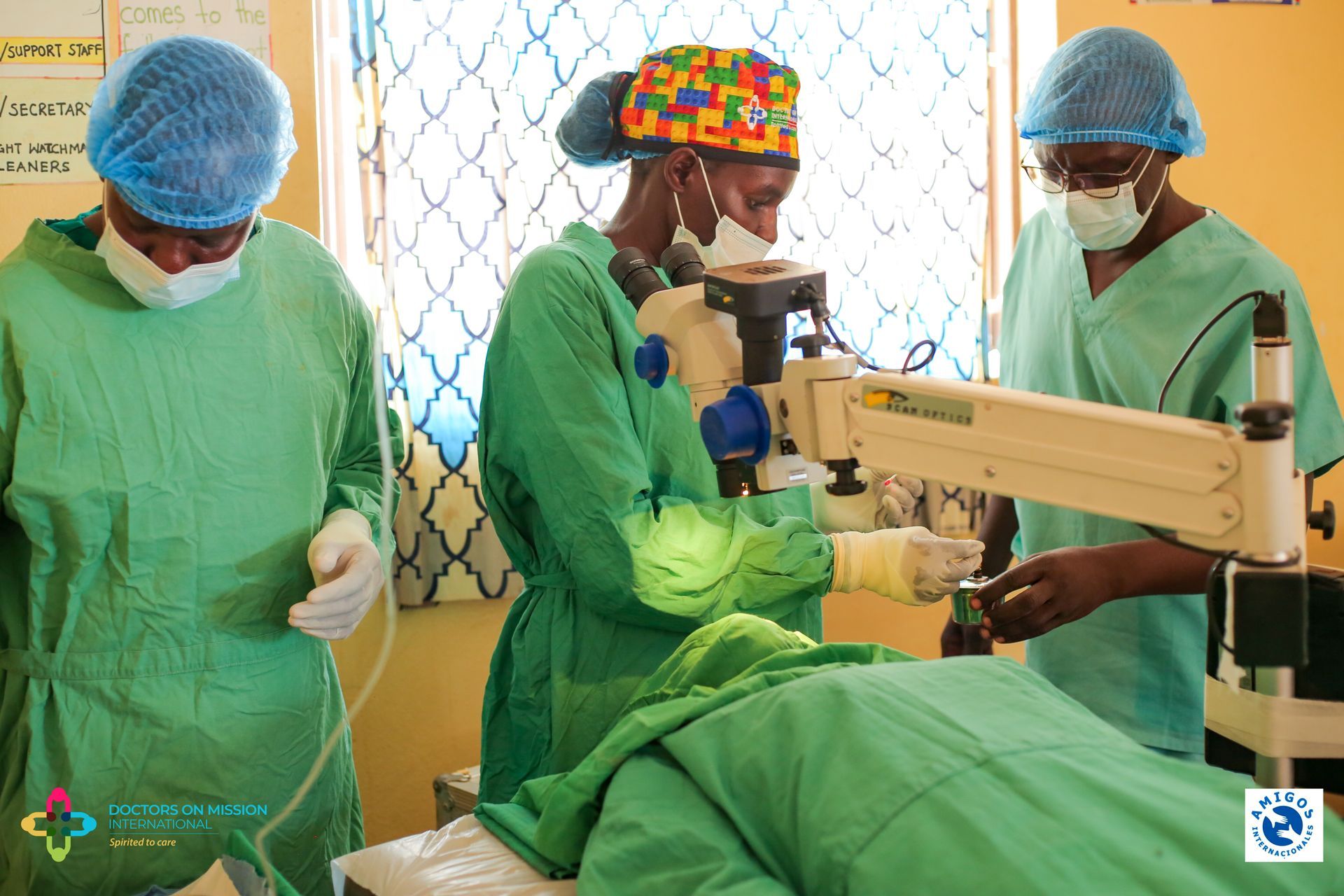 A group of surgeons are working on a patient with a microscope.