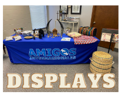 A table with a blue cloth that says amigos on it