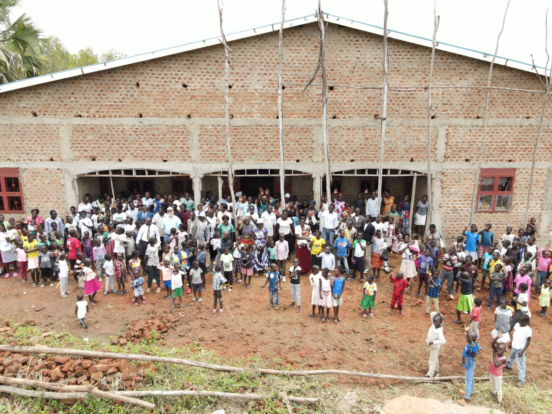 A large group of people are standing in front of a building.