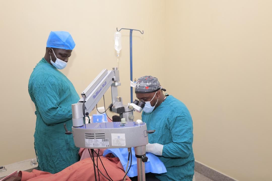 Two surgeons are working on a patient in an operating room.