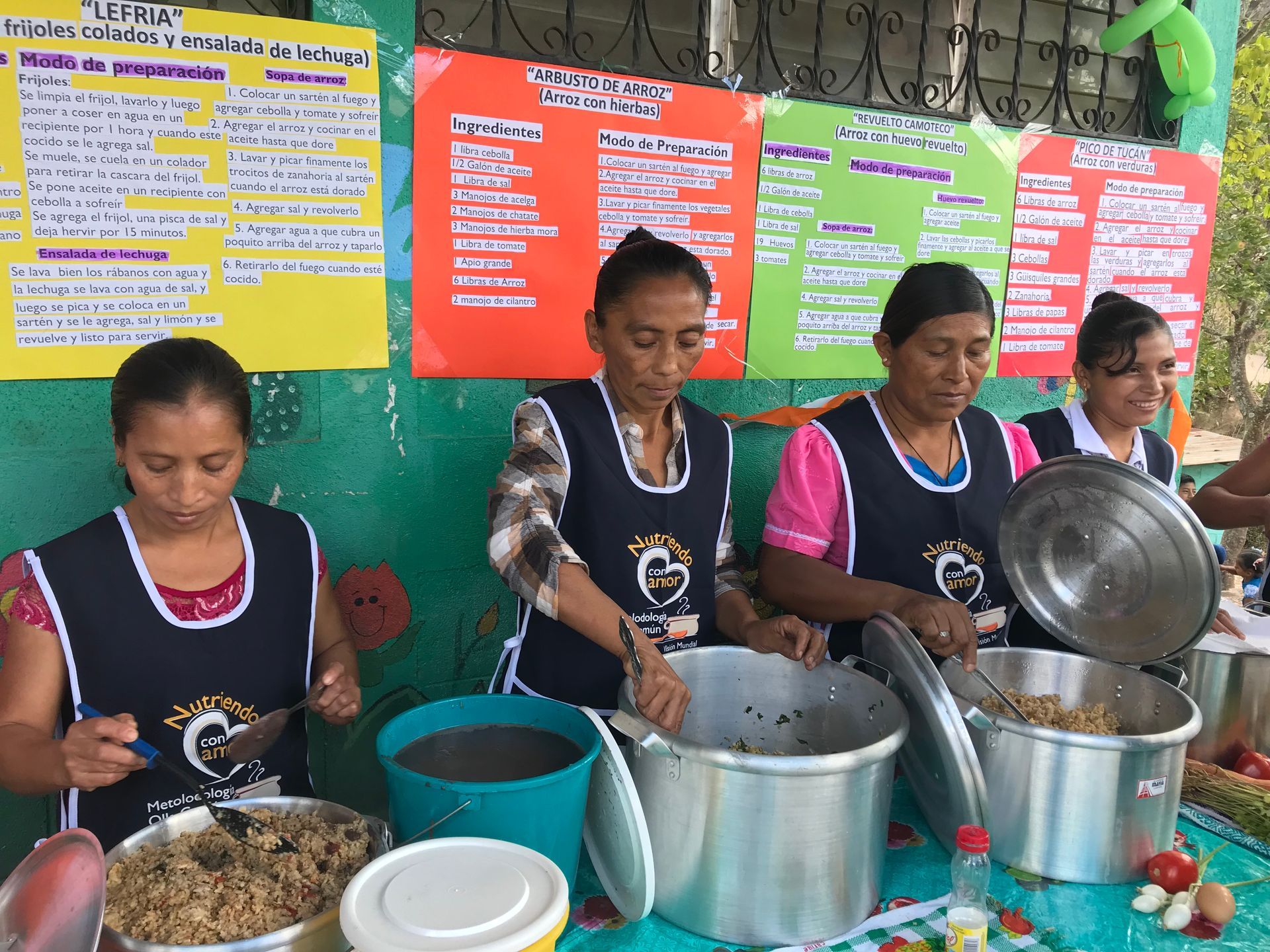 A group of women are preparing food on a table
