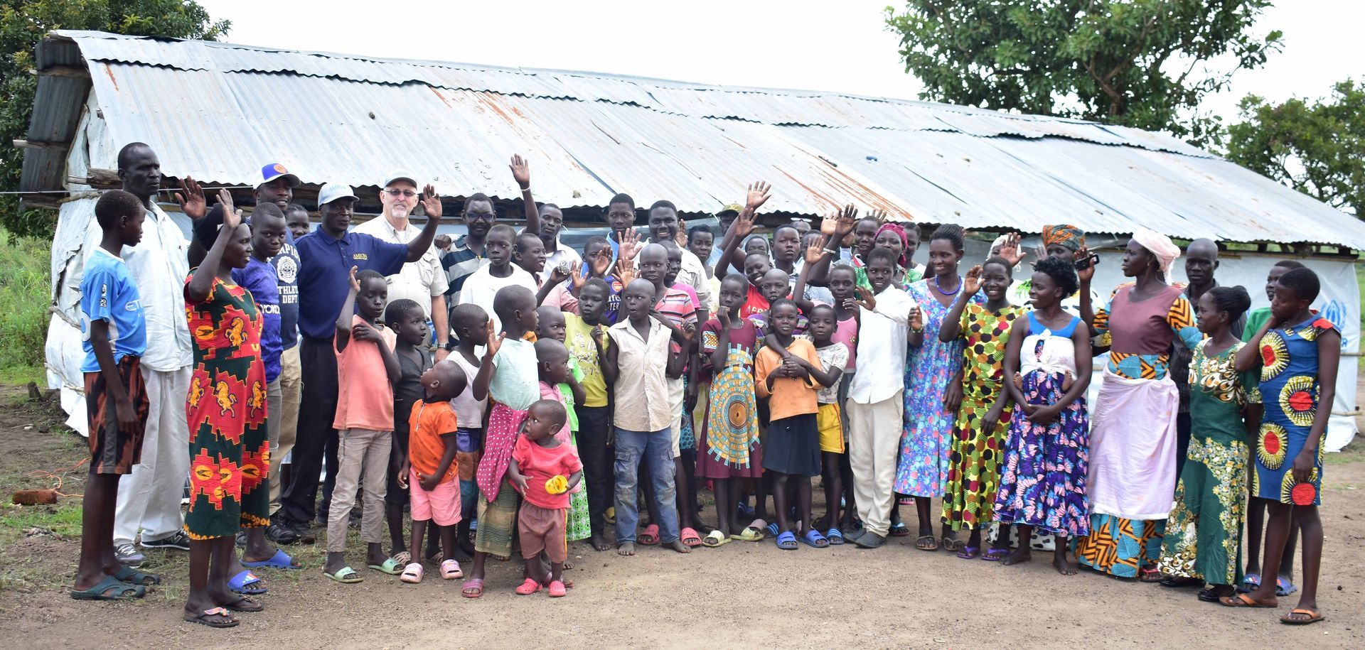 A large group of people are posing for a picture in front of a building.