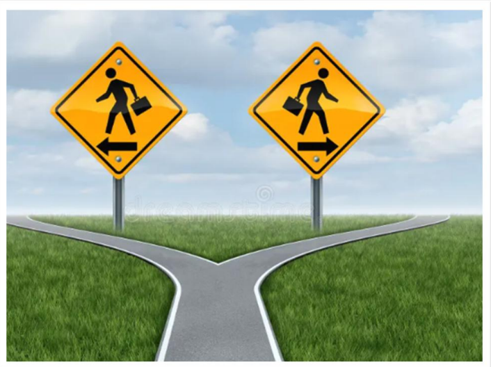 Two yellow road signs with walking figures, pointing left and right, over a forked road.