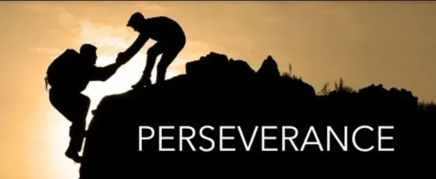 Silhouetted figures helping each other climb a mountain, with