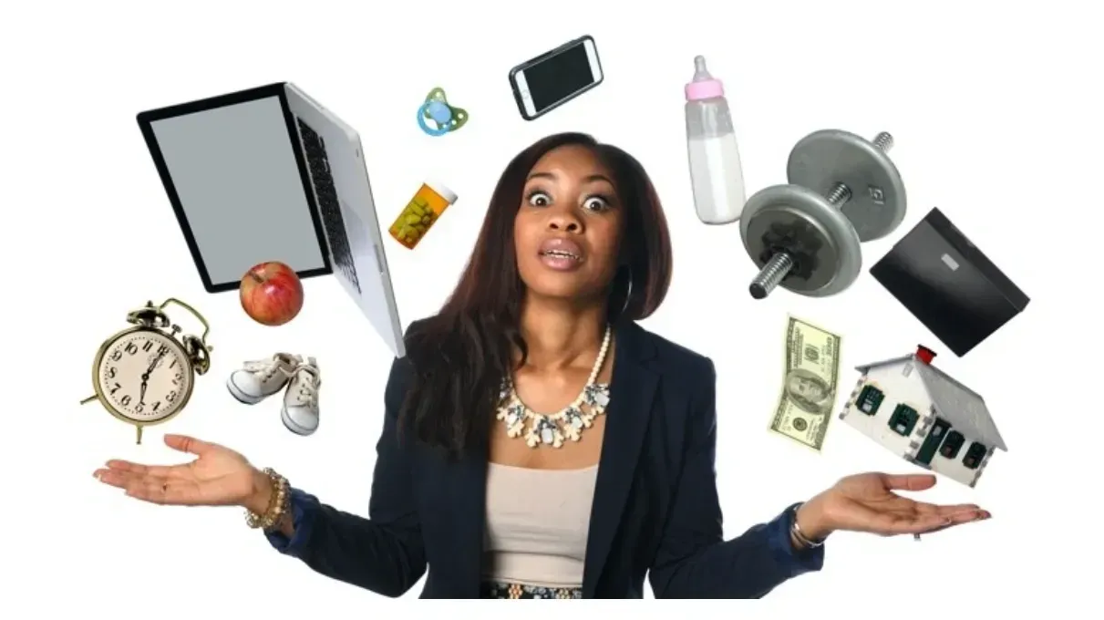 Woman with open palms overwhelmed by items symbolizing work, family, and finances.