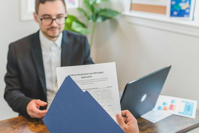Real estate professional reviewing mortgage and debt records