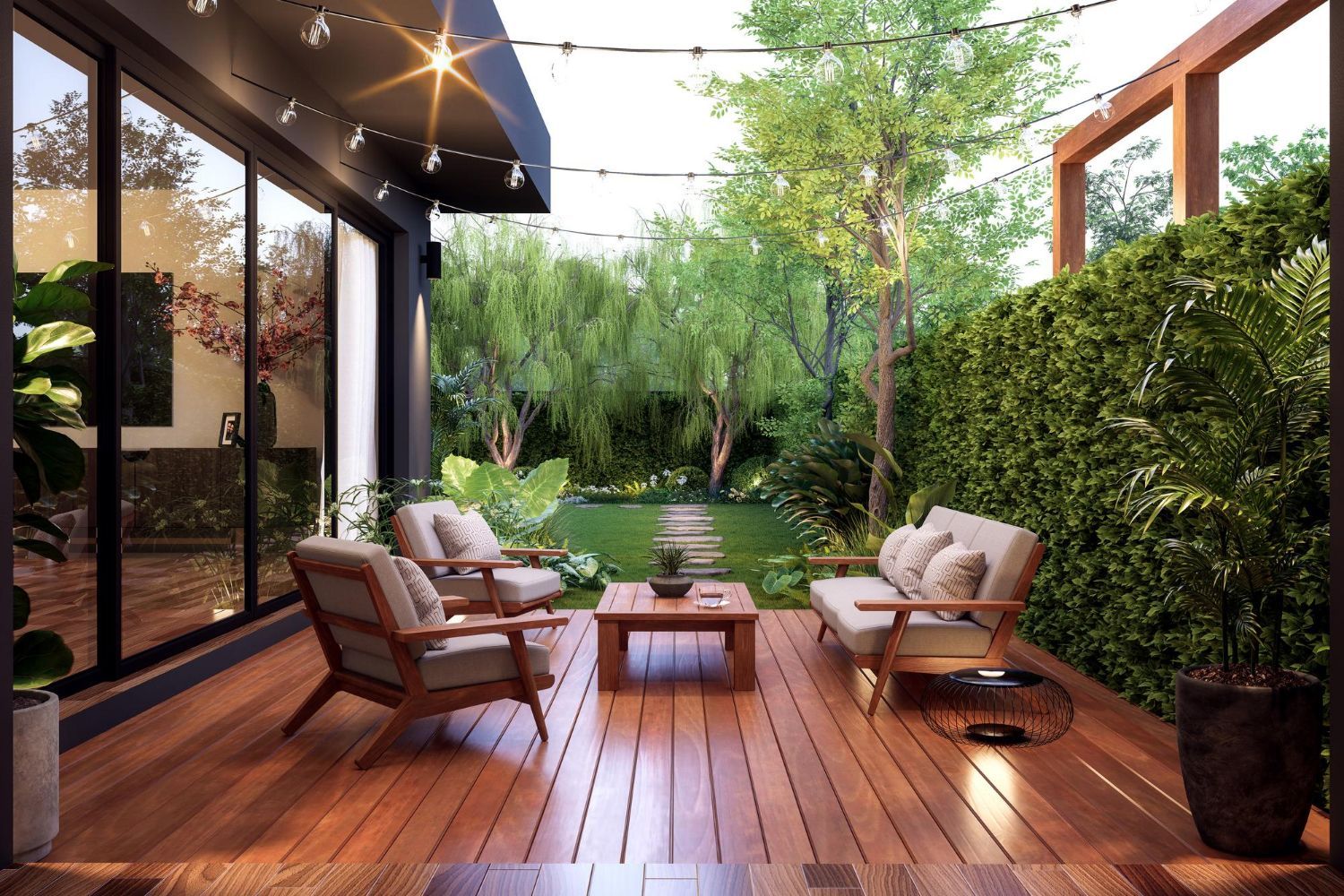A wooden deck with a sofa and two armchairs around a coffee table, overlooking a lush green garden at twilight.