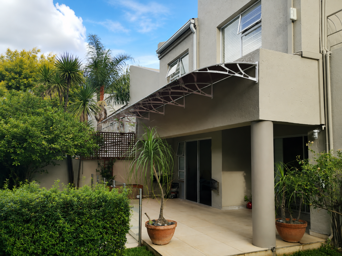 Reboss patio awning providing shade over an outdoor entertainment area in South Africa
