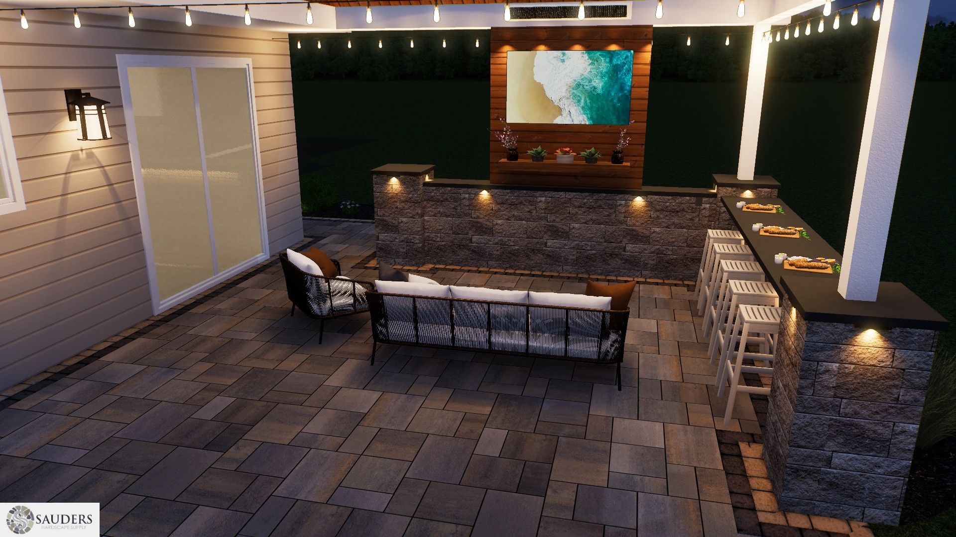 Patio with bar, TV, seating, and string lights, at night. Dark gray pavers and stone walls.